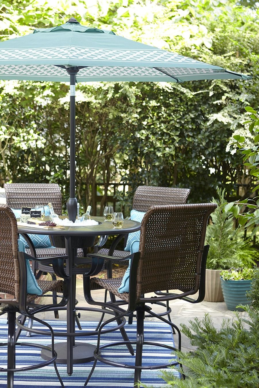 A Bar Height Patio Table Features An Umbrella For Shady pertaining to size 900 X 1350