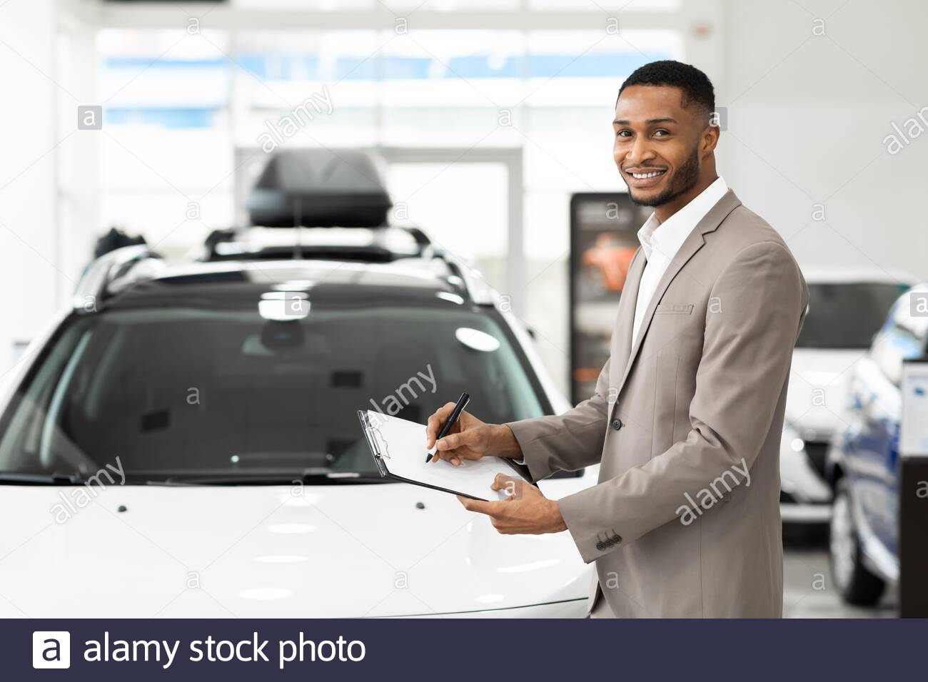 Black Insurance Agent Standing Near Automobile Holding inside size 1300 X 956