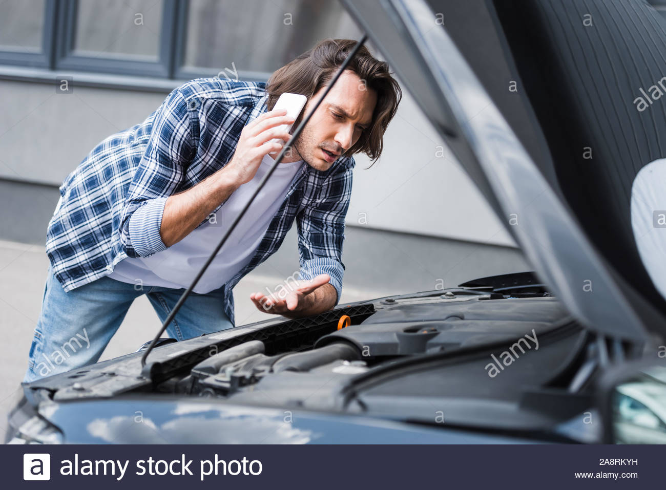 Confused Man Talking On Smartphone And Standing Near Broken with regard to sizing 1300 X 957