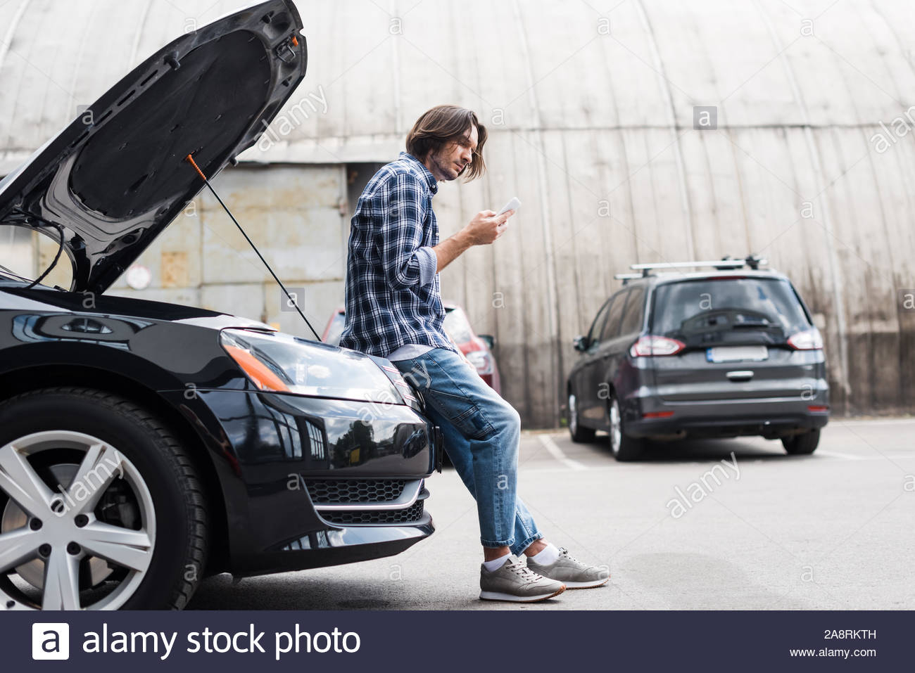 Man In Casual Clothes With Smartphone In Hand Standing Near with regard to measurements 1300 X 957