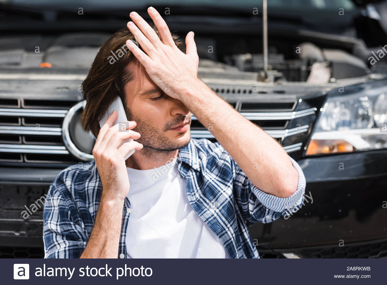 Man Talking On Smartphone Near Broken Auto With Open Hood with proportions 1300 X 957